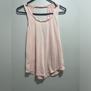 Nike light pink athletic tank top with open back detail.